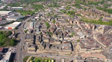 Aerial footage of the town centre of Dewsbury in West Yorkshire in the UK showing the historical city centre, Dewsbury and train tracks on a sunny summers day