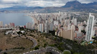 Aerial footage showing the whole of Benidorm in Alicante, you can see everywhere included Playa de Levante beach, Balcn del Mediterrneo and all the high rise hotels and golden sandy beaches.