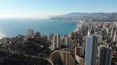 Aerial footage of Benidorm Playa Levante beach, hotels, buildings, restaurants and the coastline and sandy beaches of Benidorm the seaside resort in Spain Alicante and golden sandy beaches.