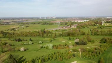 Aerial footage of the Pontefract race course located in the town of Pontefract in West Yorkshire in the UK, showing the main building and horse racing course, with the town of Castleford in the back