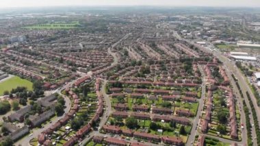 Aerial footage of the town and suburban area of Doncaster In Yorkshire, northern England, showing houses and roads with cars traveling on the road and rows of houses.