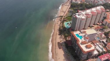 Aerial footage of the beautiful beach and town of Puerto Vallarta in Mexico, the town is on the Pacific coast in the state known as Jalisco showing hotels on the beach front