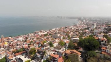 Aerial drone footage of the beautiful town centre of the town of Puerto Vallarta in Mexico, showing business, hotels and residential properties.