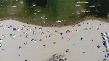 Aerial footage of the beautiful coastline of Bulgaria at the area of Sunny Beach, taken with a drone showing people sunbathing on the goldren sandy beach.