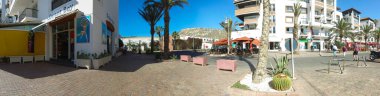 Wide panoramic photo taken in Agadir in Morocco showing the mountains with the monument in the hill known locally as Dieu la Patrie Le Roi