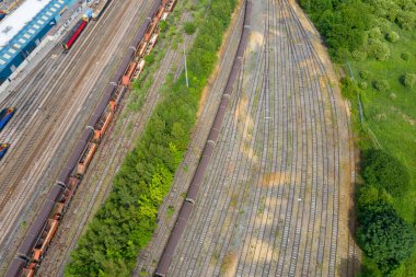 Bir tren istasyonunun hava fotoğrafı, güneşli bir yaz gününde İngiltere 'nin Leeds kentindeki Halton Moor köyündeki raylarda bir çok trenin bulunduğu depoda çalışır..