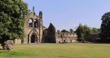 The famous Kirkstall Abbey showing the ruined Cistercian monastery in Kirkstall in the north-west of Leeds city centre in West Yorkshire in the UK on a bright sunny summers day.