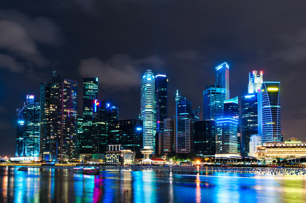 The skyline of Singapore lit up at night.