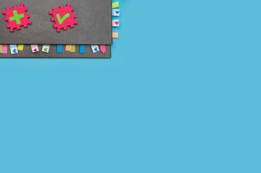 Yer imleriyle gri haftalık planlayıcı ve mavi arka planda sembolleri olan bulmacalar. İş ve kişiliğin gelişimi için karmaşık sorunları planlama ve çözme kavramı