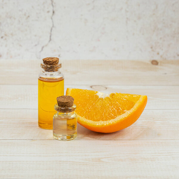 Essential oil of orange in a glass bottle with orange. Aromatherapy. The concept of natural cosmetics