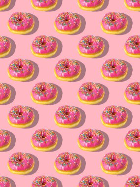 Pembe arka planda tekrarlanan pembe donut deseni. Düz yatıyordu.