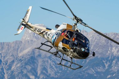 Zell am See, Austria - October 14, 2017: Commercial helicopter at airport and airfield. Rotorcraft. General aviation industry. Civil utility transportation. Air transport. Fly and flying.