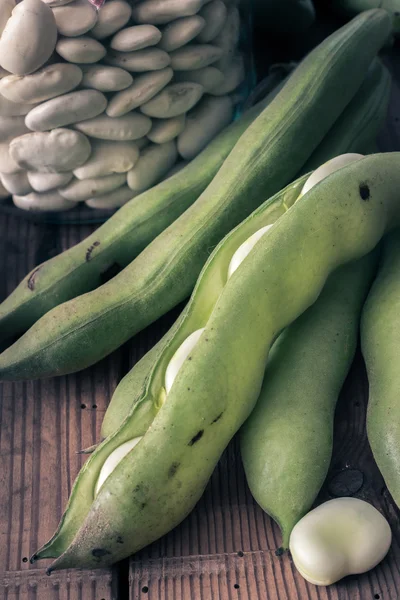 Broad Beans on a wooden Table with Jar, full of dry beans — Stock Photo, Image