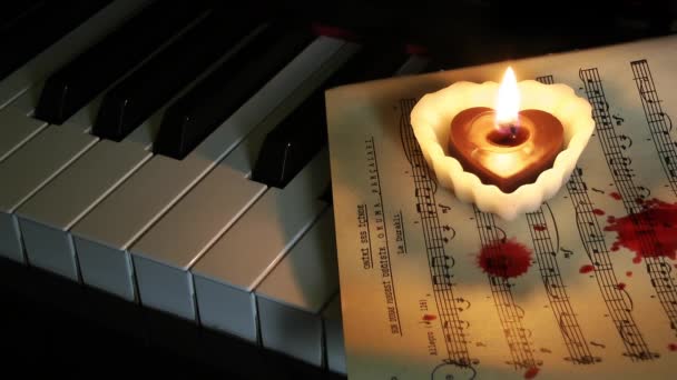 Heart Shape Candle Piano and Blood Drops on Music Sheet — Stock Video