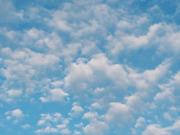 Full frame of pretty blue sky with pale white cloud formation. High quality photo