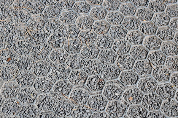Background of plastic and gravel hardstanding over grass with hexagonal design - image. Stable surface allowing cars to park on ground. High quality photo with copy space.
