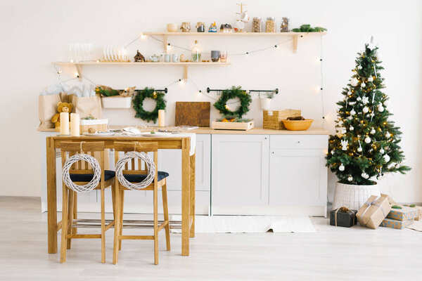 Christmas kitchen decor. Rustic cuisine at Christmas. Details of scandinavian cuisine in wooden color. Table with festive setting.