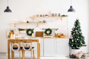 İskandinav mutfağının içinde Noel ve Yeni Yıl için dekore edilmiş yemek masaları var..