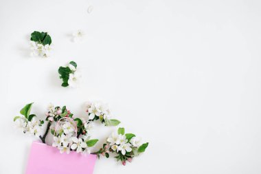 A bouquet of flowering branches of an apple tree in a shopping bag on a white background. Top view Flat lay Copy space. Spring discount concept. Seasonal sale.