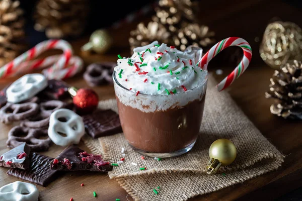 Close up view of a cup of hot chocolate with whip cream and sprinkles on top. — Stock Photo, Image