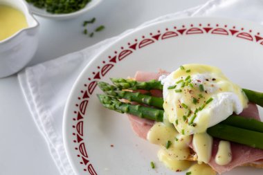 Hollandaise sosu ve soğanla kaplı bir tabak yumurtayı kapat..