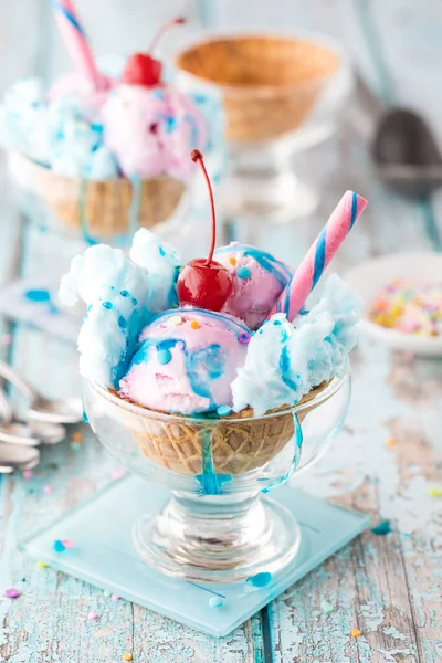 Refreshing cotton candy ice cream sundaes dripping in sticky cotton candy syrup, ready for eating.