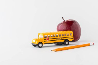 Close up of items to depict a back to school concept, against a white background. 