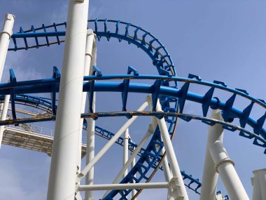 Old inverted roller coaster painted in blue and white