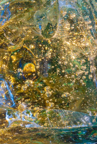 Bubbles trapped in large glass chunk — Stock Photo, Image