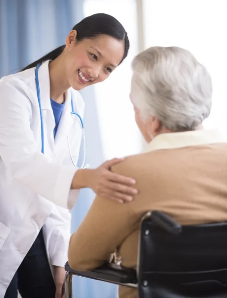Doctor Consoling Senior Woman Sitting In Wheelchair — Stock Photo, Image