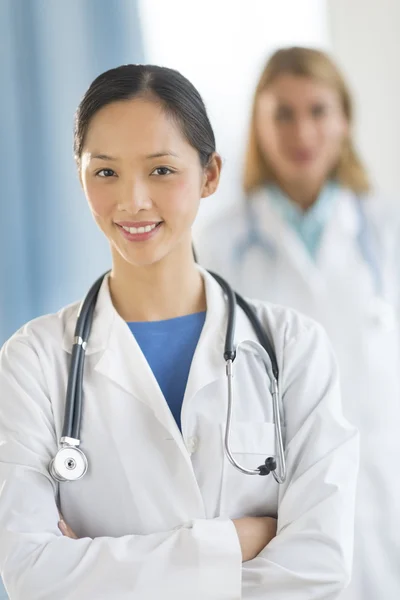 Confident Asian Doctor Standing Arms Crossed In Clinic — Stock Photo, Image