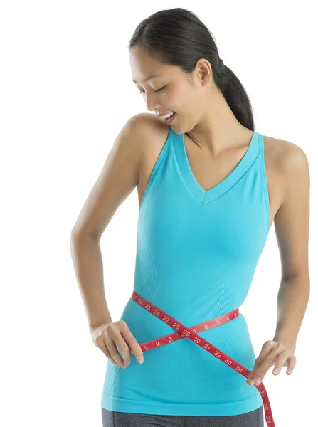 Mujer feliz midiendo su cintura —  Fotos de Stock