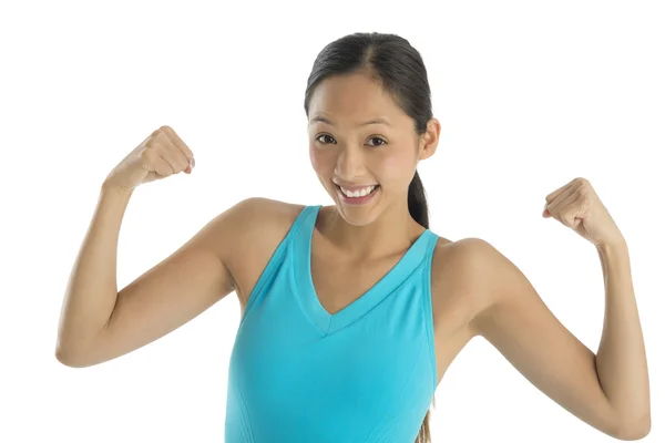 Mujer alegre en ropa deportiva flexionando sus brazos —  Fotos de Stock