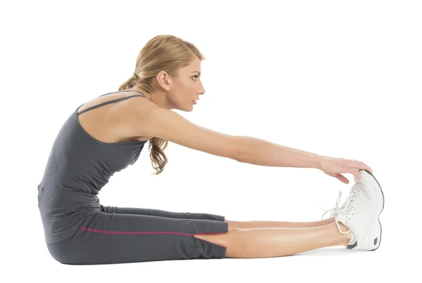 Young Woman Stretching To Touch Her Toes — Stock Photo, Image