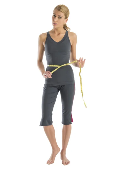 Frustrado mulher segurando fita métrica em torno da cintura — Fotografia de Stock