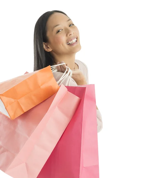 Portret van vrolijke vrouw met shopping tassen — Stockfoto