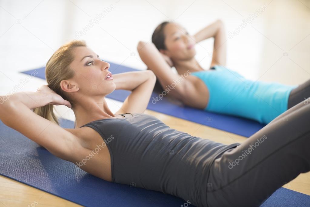 Women Doing Sit-Ups At Health Club