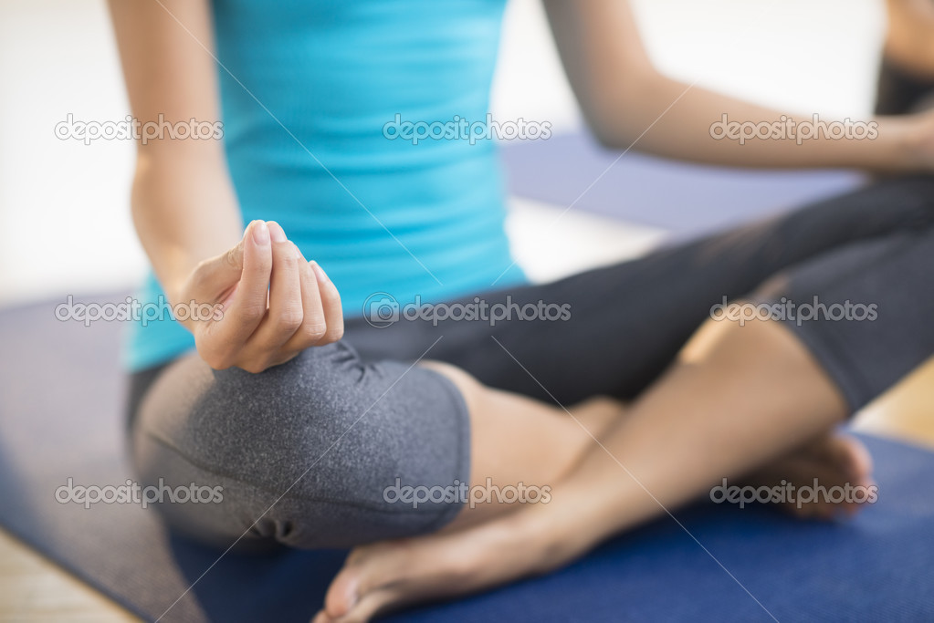 Low Section Of Woman Practicing Yoga At Gym