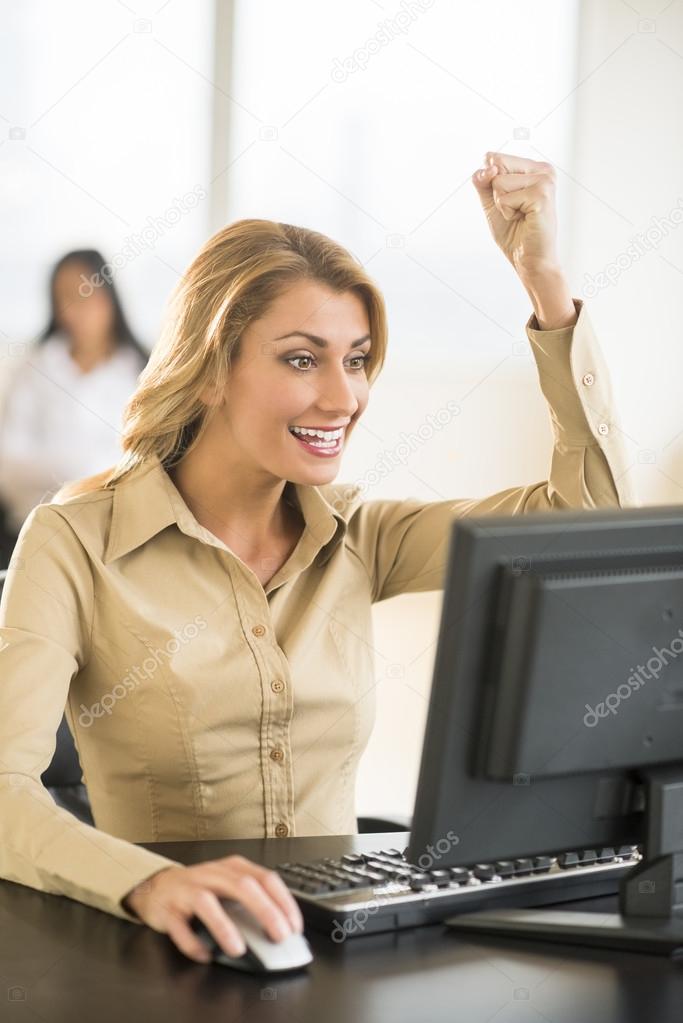 Successful Businesswoman Using Computer At Desk