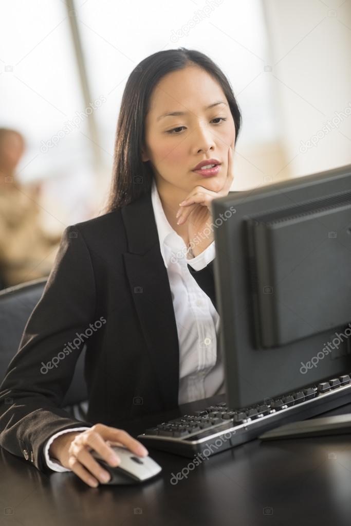 Beautiful Businesswoman Using Computer At Desk In Office