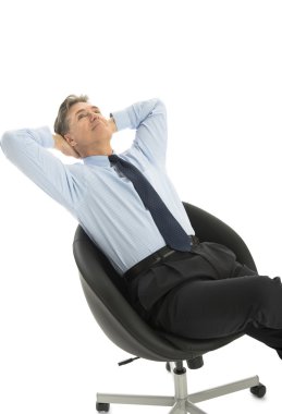 Relaxed Businessman Looking Up At Copy Space