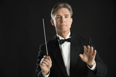 Confident Orchestra Conductor Directing With His Baton clipart