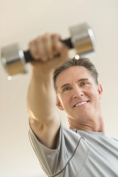 Happy Man Weightlifting Against Beige Background — Stock Photo, Image