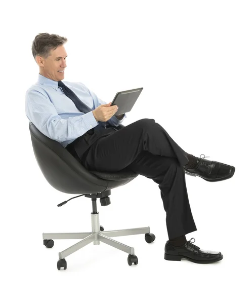 Happy Businessman Using Tablet Computer While Sitting On Office — Stock Photo, Image