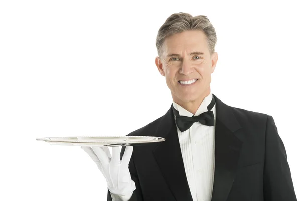 Retrato de camarero feliz en esmoquin con bandeja de servir —  Fotos de Stock