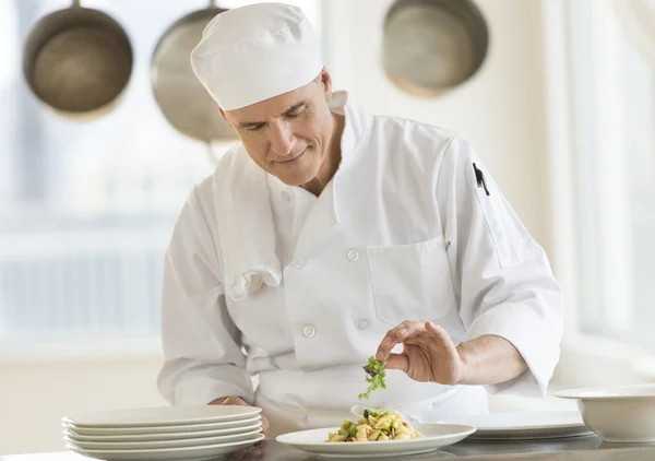 Chef Garnishing Dish In Commercial Kitchen — Stock Photo, Image