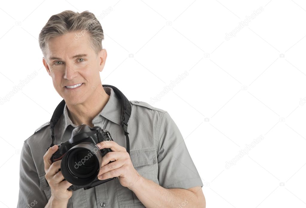 Confident Male Photographer With Camera And Umbrella Lights