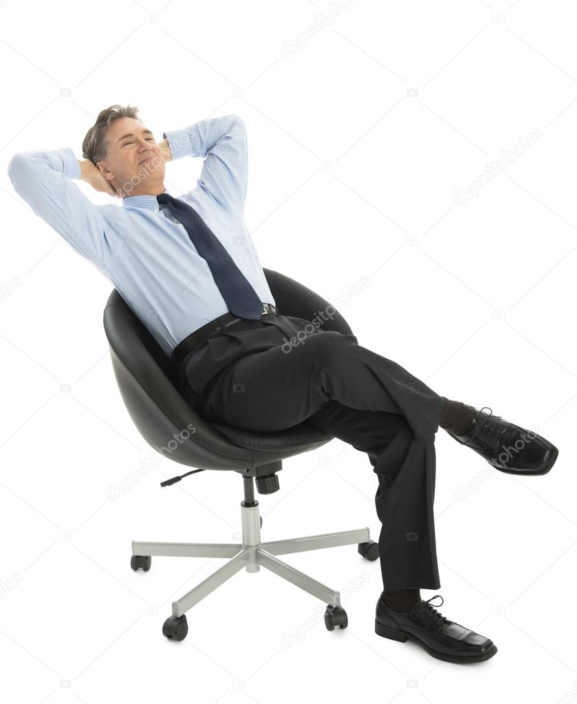 Relaxed Businessman With Hands Behind Head Sitting On Office Cha