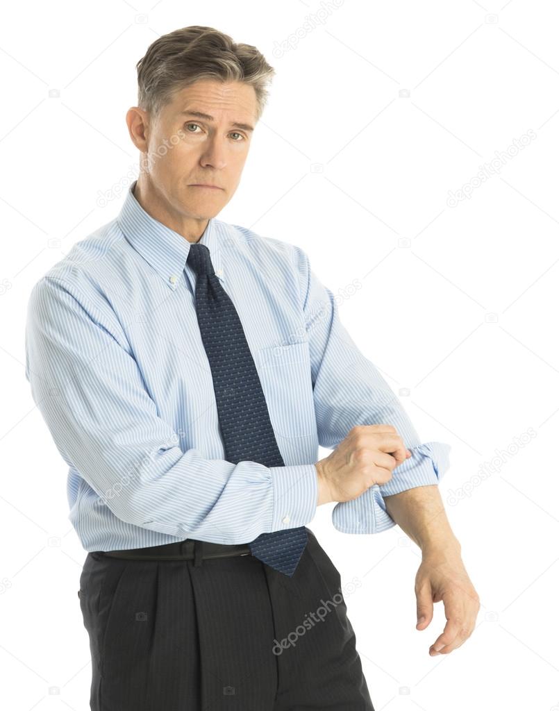 Portrait Of Tired Businessman Rolling Up His Sleeves