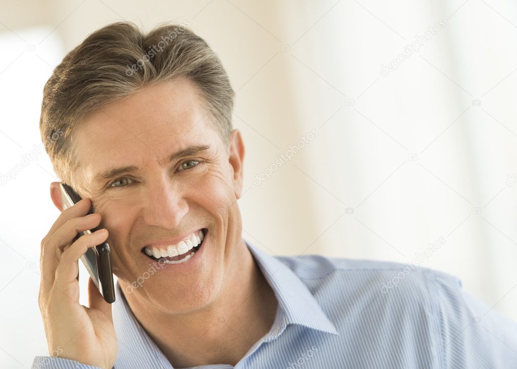 Cheerful Businessman Answering Smart Phone